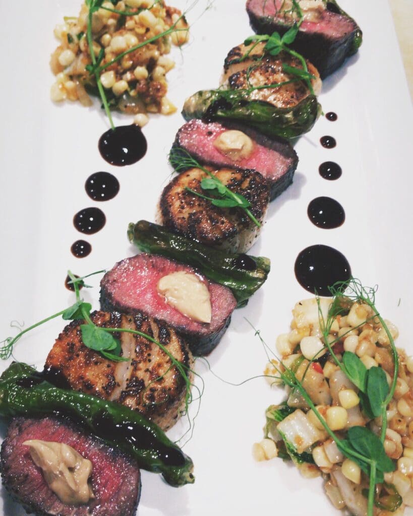 Shishimi seared scallops, grilled wagyu, shoyu butter, soy reduction, corn succotash, shishito peppers